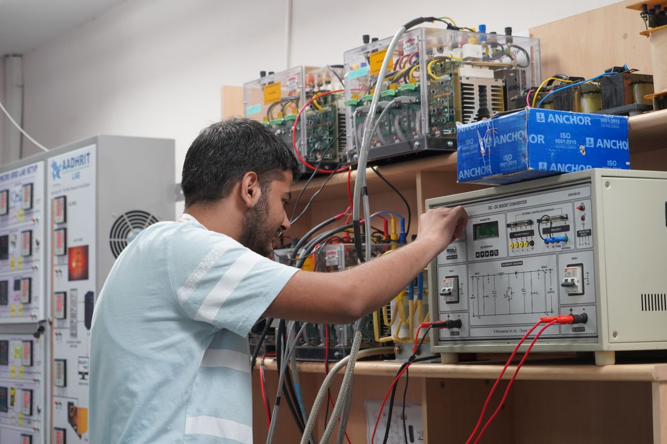 Indian engineering student working with electronic laboratory equipment